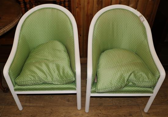 A pair of white-painted bergeres with reeded frames